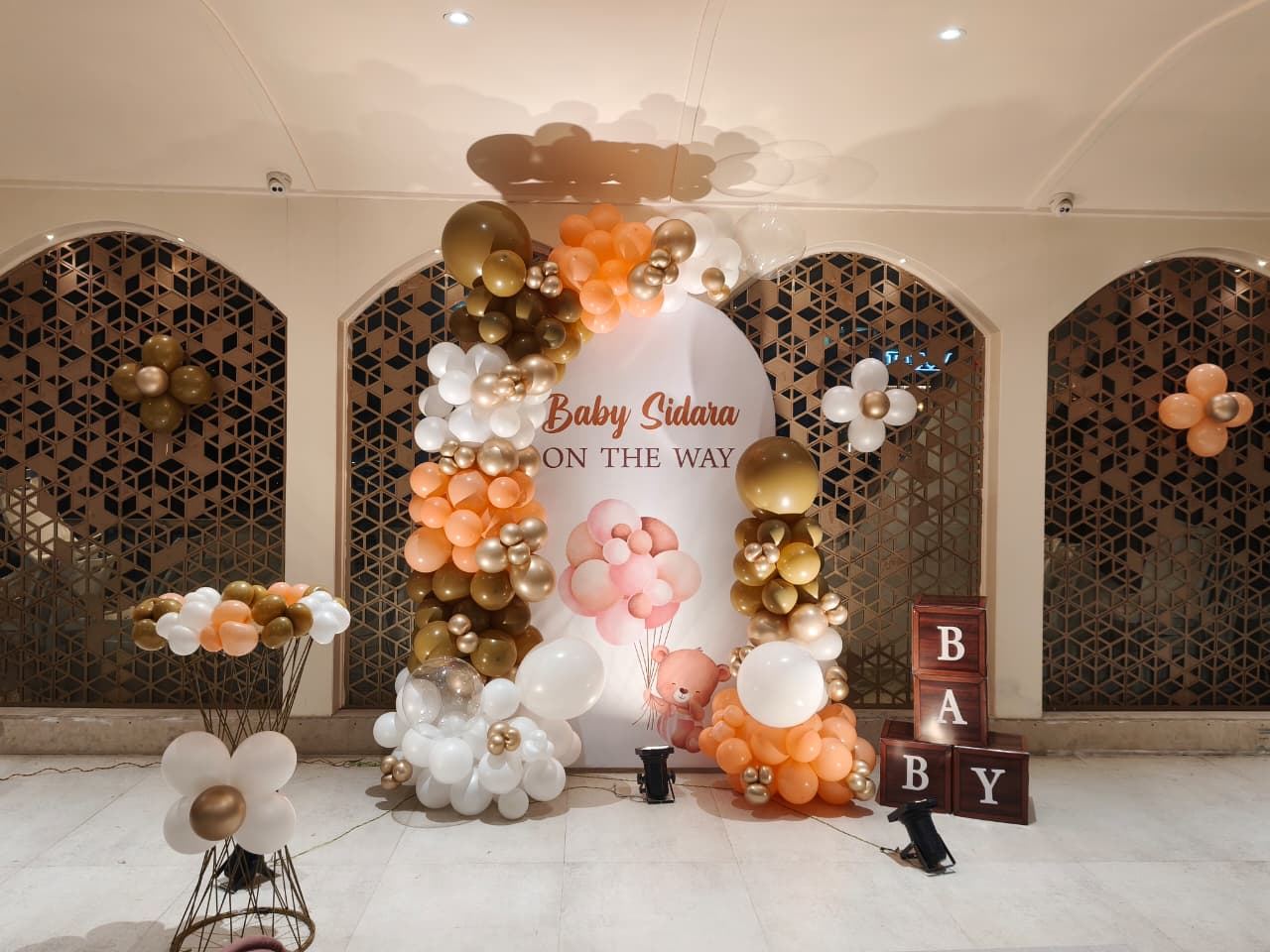 Peach and gold balloon backdrop for a baby shower by Mayur Events Bilaspur