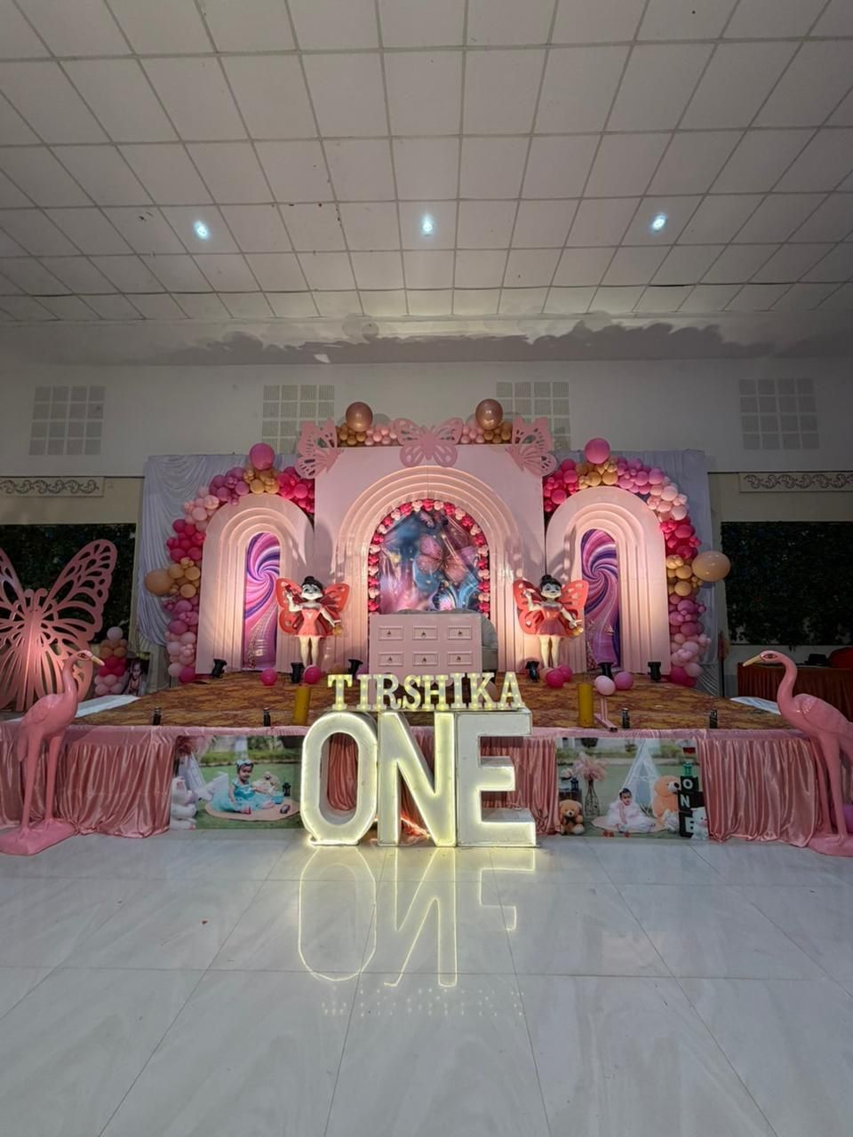 Full view of pink butterfly theme first birthday stage decoration by Mayur Events Bilaspur