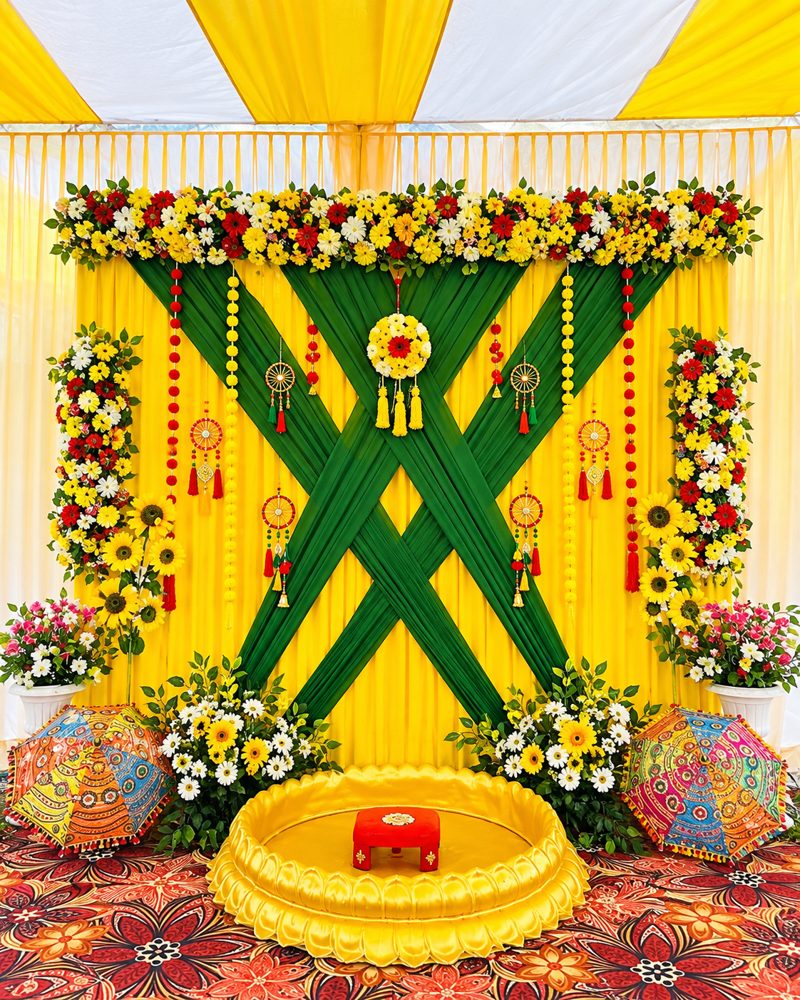 Yellow and green sunflower theme haldi ceremony backdrop with decorated umbrellas by Mayur Events Bilaspur