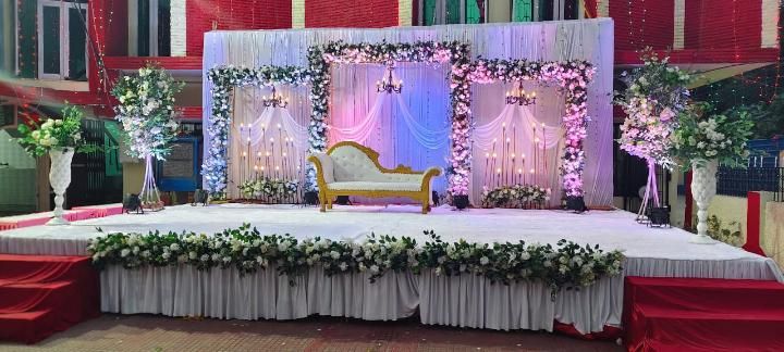 Pink and white floral reception stage decoration with ambient lighting by Mayur Events Bilaspur