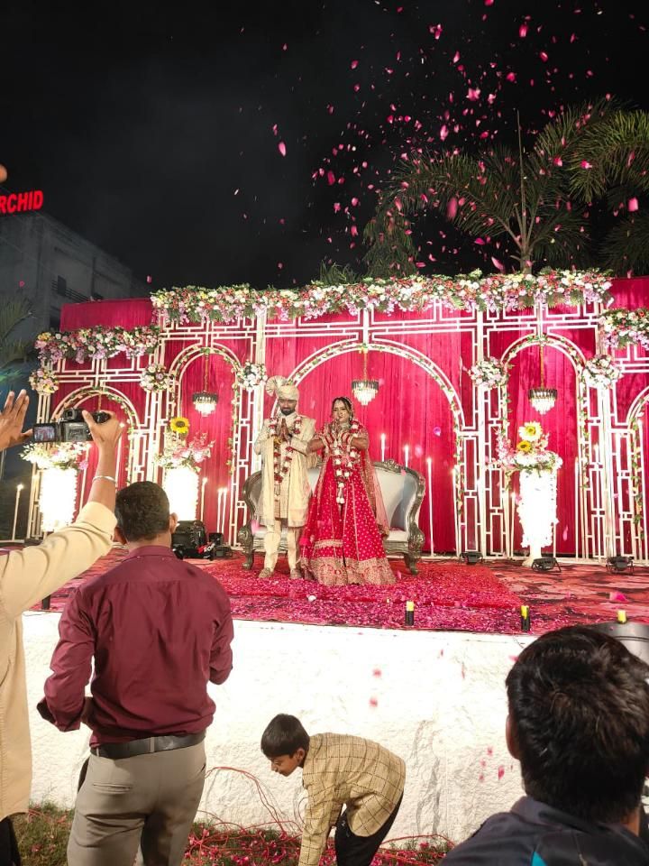 Bride and groom varmala ceremony with rose petal shower on stage by Mayur Events Bilaspur