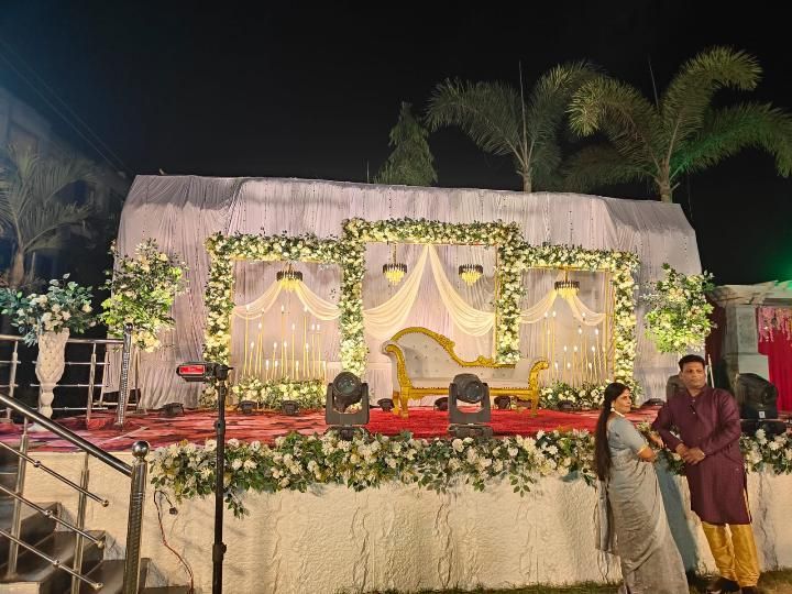 White and gold floral wedding stage decoration with chandeliers by Mayur Events Bilaspur